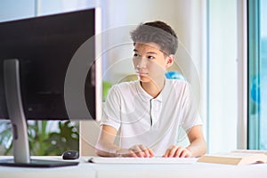 Child doing homework on computer. Online class