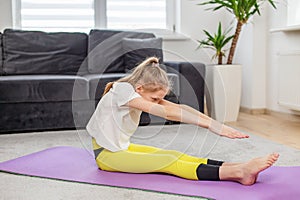 Child Doing Stretching Exercise on Yoga Mat