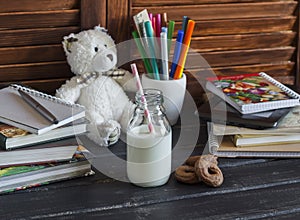 Child domestic workplace and accessories for training and education - books, journals, notepads, notebooks, pens, pencils, table