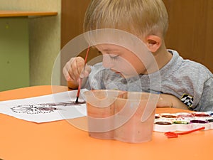 Child with Down syndrome is drawing