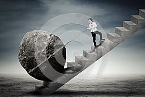 Child dragging stone on the stairs