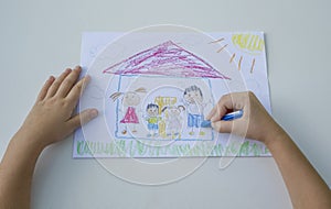 Child draw with crayons on paper, happy family