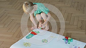 Child Draw On A Large Sheet Of Paper. Paints.