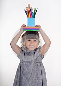 Child with draw and paint school supplies. Kids happy to go back to school.