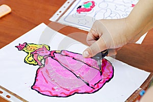 Child draw a woman. Child drawing picture outdoors in summer