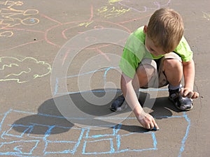 Child drawing on asphalt