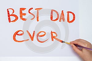 Child is drawing Father`s day greeting card