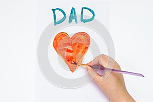 Child is drawing Father`s day greeting card