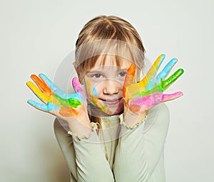 Child drawing. Happy girl art school student with bright painted hands on white background