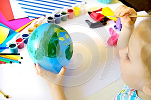 Child drawing pattern of flower and plants on the balloon. Earth day. Arts  crafts concept. art learning and education