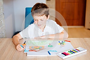 Child drawing picture of boy going to school.