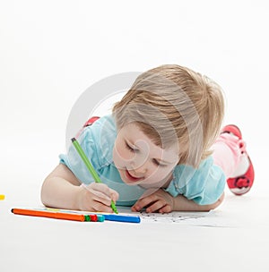 Child drawing a picture with colorful felt-tip pens