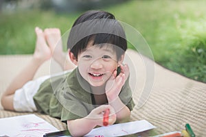 Child drawing picture with crayon