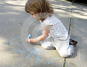 Child drawing on sidewalk