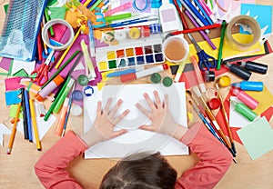 Child drawing top view. Artwork workplace with creative accessories. Flat lay art tools for painting.