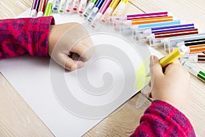 A child draws a birthday card. Drawing made by a child with colorful felt-tip pens. A happy family. Children`s drawing