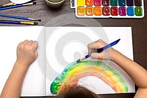 A child draws leafs on a tree. Ideas for drawing with finger paints. Finger painting for kids on white background