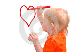 Child draws red pencil a heart