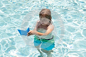 Child dreams of travel and adventure. Happy summer holidays concept. Dreams of sea, adventures and travel. Child playing