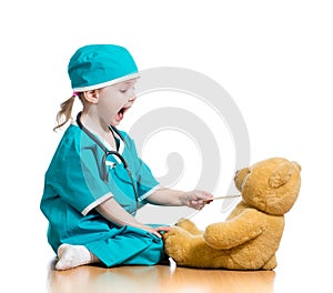 Child dressed as doctor playing with toy