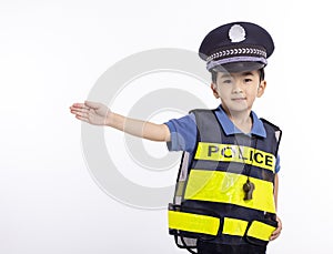 child dressed as a police officer standing before white background