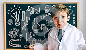 Child dressed as a scientist and chalkboard