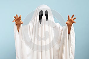Child dressed up in white costume of scary ghost for Halloween