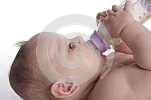 Child drinking from baby bottle