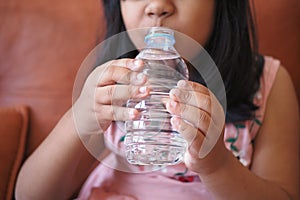 child drinking bottle of water