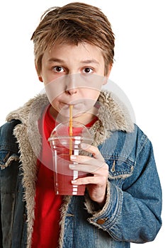 Child drinking fresh fruit juice through a straw