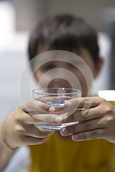 Child drinking a glass of pure water