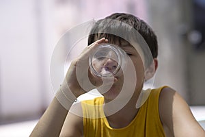 Child drinking a glass of pure water