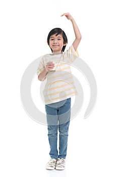 Child drinking milk from a glass and measuring himself  on white background isolated