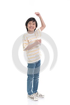 Child drinking milk from a glass and measuring himself  on white background isolated