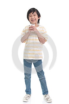 Child drinking milk from a glass on white background isolated