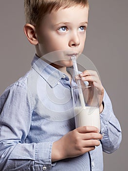 Child drinking milk. Little Boy enjoy milk cocktail