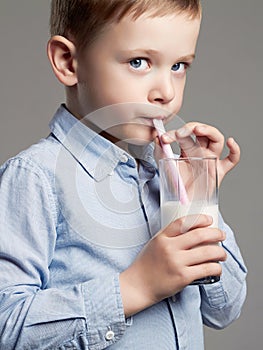 Child drinking milk. Little Boy enjoy milk cocktail
