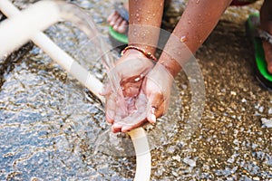 Child drinking tater from a tap