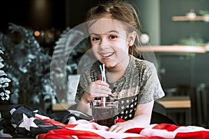 A child drinks a drink from a straw