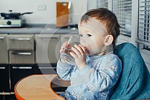 Child drinks water from a glass