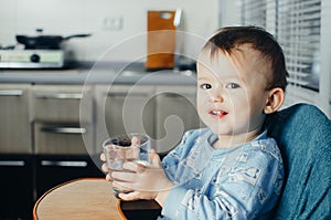 Child drinks water from a glass