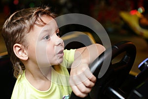 Child driving a car simulator