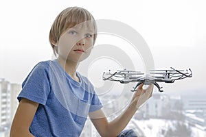 Child with drone against window at home. Technology, leisure toys concept