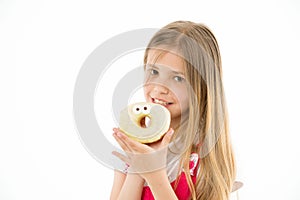 Child eat donut isolated on white. Little girl with glazed ring doughnut. Kid with junk food. Food for snack and dessert