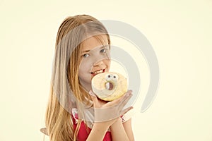 Child eat donut isolated on white. Little girl with glazed ring doughnut. Kid with junk food. Food for snack and dessert