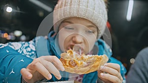 Child eat pizza cheese four. Close up of young girl woman eating pizza and chewing in outdoor restaurant. Kid children