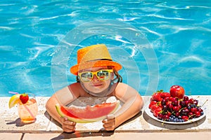 Child eat watermelon. Summer child by the pool eating fruit and drinking lemonade cocktail. Summer kids vacation concept