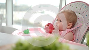 Child eating apple. Baby healthy food concept. Sweet baby eating fruit