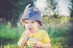 Child eating apple outdoors