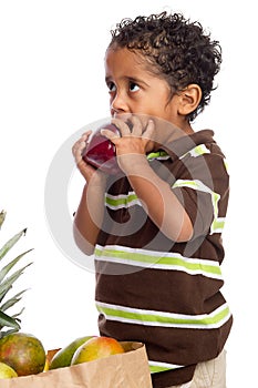 Child Eating Apple Picked from Grocery Bag